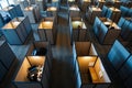 This photo shows a busy room with numerous cubicles, each equipped with bright lights, Aerial view of an office cubicle, AI