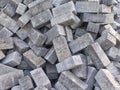 The photo shows a close-up view of a pile of rectangular concrete paving blocks stacked irregularly Royalty Free Stock Photo