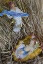 Angel with baby Jesus in a manger shows a Gloria banner from above in the straw.