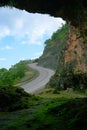 mountain road view from rock natural cave Royalty Free Stock Photo