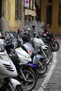 Motorcycles and mopeds are parked in Florence.
