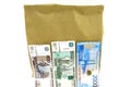 Universal paper bag eco-friendly with three bills on white background Royalty Free Stock Photo