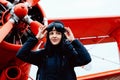 Portrait of young beautiful woman pilot in front of airplane Royalty Free Stock Photo