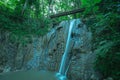 Beautiful mountain waterfall, milky water, in tropical jungle on a sunny day