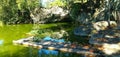 Photo shows a submerged cave, with a small pier of fishing boats, the cave is located in the former yard of the emperor Dom Pedro