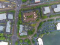 The photo shows a suburb. View from above. Shooting from a drone. Houses, green trees, bushes, lawns. Also in the photo you can