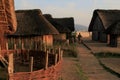 ancient viking city Haithabu with thatched viking hauses and man in costume