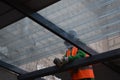 man in uniform installing a transparent roof