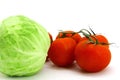 Red tomatoes on a branch, and young cabbage sprouts on white background Royalty Free Stock Photo
