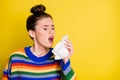 Photo of sick cold brown bun haired girl sneeze hold napkin closed eyes isolated on shine bright color background Royalty Free Stock Photo