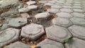 Photo from the side of the hexagonal paving which is starting to break down. Selective focus. Wide view. Background concept