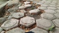 Photo from the side of the hexagonal paving which is starting to break down. Selective focus. Wide view. Background concept