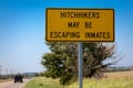 Sign with the inscription \'Hitchikers May be Escaping Inmates\'