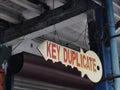 Photo sign of wooden key duplicate hang on in front of shoplots. Royalty Free Stock Photo