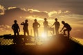 Photo Silhouette construction workers on building roof, showcasing labor Royalty Free Stock Photo