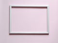 Photo silver frame with space for text on pink background.