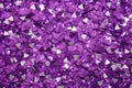 photo of silver glitter scattered on a vibrant purple surface