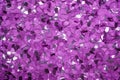 photo of silver glitter scattered on a vibrant purple surface