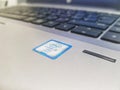 Photo of a silver HP laptop bearing the Intel CORE i5 vPro holographic sticker Royalty Free Stock Photo