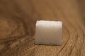 Photo of a single sugar cube on a wooden brown surface Royalty Free Stock Photo