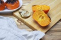 A photo of the sliced antioxidant grilled mandarine fruits and limes on the wooden table. Food for longevity, long life. New Japan