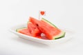 sliced fresh watermelon on a plate with a cute red heart flag.