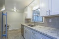 Photo of a small compact kitchen with white shaker cabinets