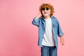Photo of small ginger funny disco boy enjoy rest weekend wear sunglass jeans jacket pink color background