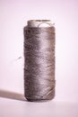 photo of a small gray cotton sewing roll.