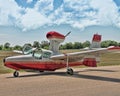 Photo of a small plane on a runway with clouds in the sky