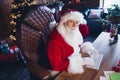 Photo of smart busy santa claus dressed red costume communicating modern device indoors christmas north pole home