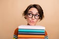 Photo of smart minded girl pile stack book look interested empty space contemplate isolated on beige color background