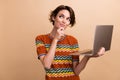 Photo of smart pretty girl hand touch chin hold netbook look empty space brainstorming isolated on beige color Royalty Free Stock Photo