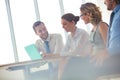 Smiling business colleagues discussing at table in new office during meeting Royalty Free Stock Photo