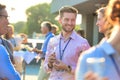 Smiling business colleagues talking during success party on rooftop