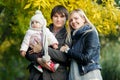 Photo of smiling family with daughter on nature in autumn Royalty Free Stock Photo