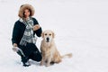 Photo of smiling girl with dog in winter park Royalty Free Stock Photo