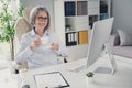 Photo of smiling happy lady clerk wear white shirt having coffee pause indoors workplace workstation