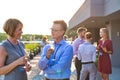 Smiling mature business colleagues talking at rooftop during success party Royalty Free Stock Photo