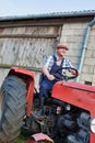 Smiling mature farmer driving tractor Royalty Free Stock Photo