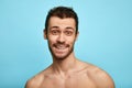 Photo of smiling mature man standing isolated over grey wall background naked. Looking camera. Royalty Free Stock Photo