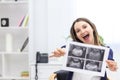 Photo of smiling pregnant woman holding ultrasound result. Royalty Free Stock Photo