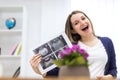 Photo of smiling pregnant woman holding ultrasound result. Royalty Free Stock Photo