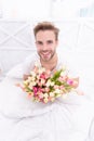 photo of smiling romantic man with march tulips bouquet Royalty Free Stock Photo