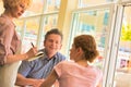 Smiling waitress taking order from customers sitting at restaurant Royalty Free Stock Photo