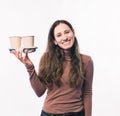 Photo of smiling young woman holding two cups of coffee to go Royalty Free Stock Photo