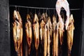 photo of smoked fish hanged inside of a chorkor oven