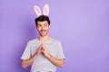 Photo of sneaky guy hold fingers look empty space wear bunny ears white striped t-shirt isolated purple background