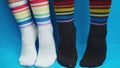 Shooting of black and white socks with rainbow colors, allegory