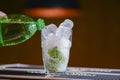 Photo of soda being poured into a glass with ice cubes and mint ina bar. Bar, cafe or restaurant photo concept. Royalty Free Stock Photo